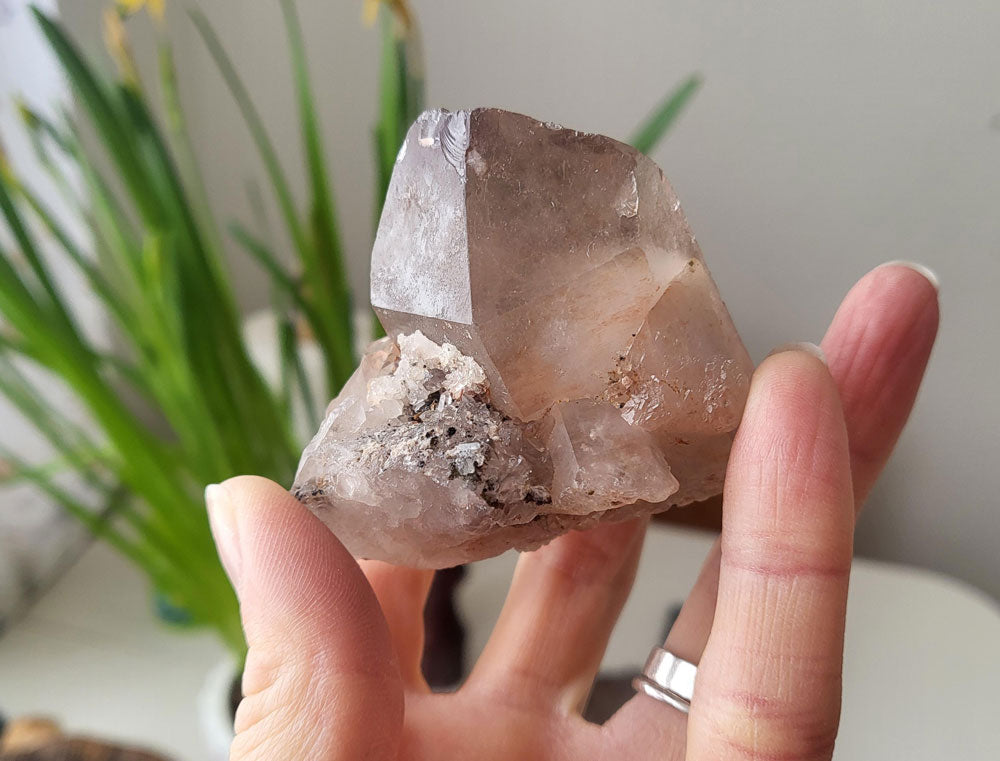 Smokey quartz crystal in hand