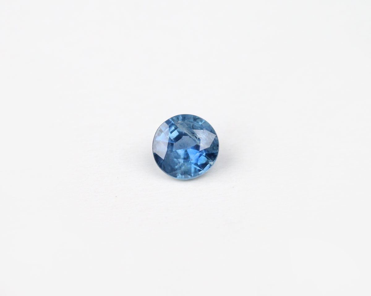 Blue faceted sapphire on a white background