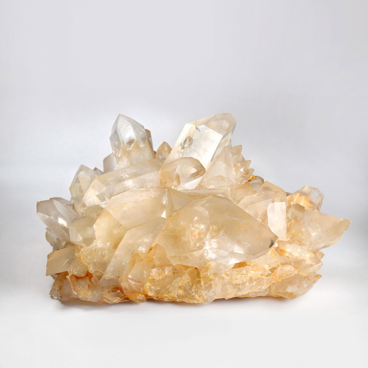 Tangerine quartz cluster on a light gray background
