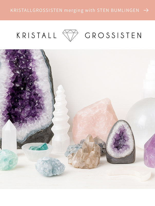 A range of natural crystals and stones on a white background with a name of the wholesale company Kristallgrossisten