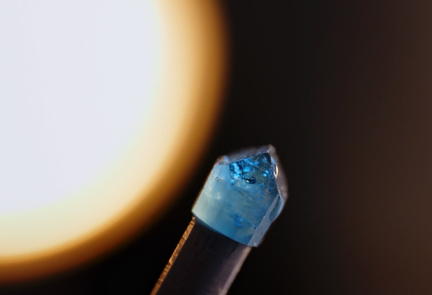 Close-up of a blue gemstone on a black background