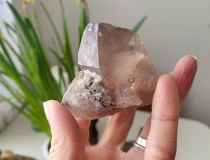 Smokey quartz crystal in hand